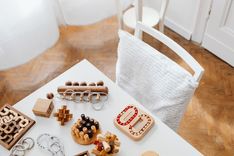 A collection of wooden puzzle toys arranged on a modern table in an indoor setting, perfect for encouraging intellectual play.